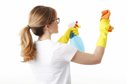 Technician handling cleaning chemicals with care and ventilation